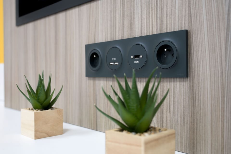 Modern in-room connectivity panel with integrated power and media outlets for added convenience.