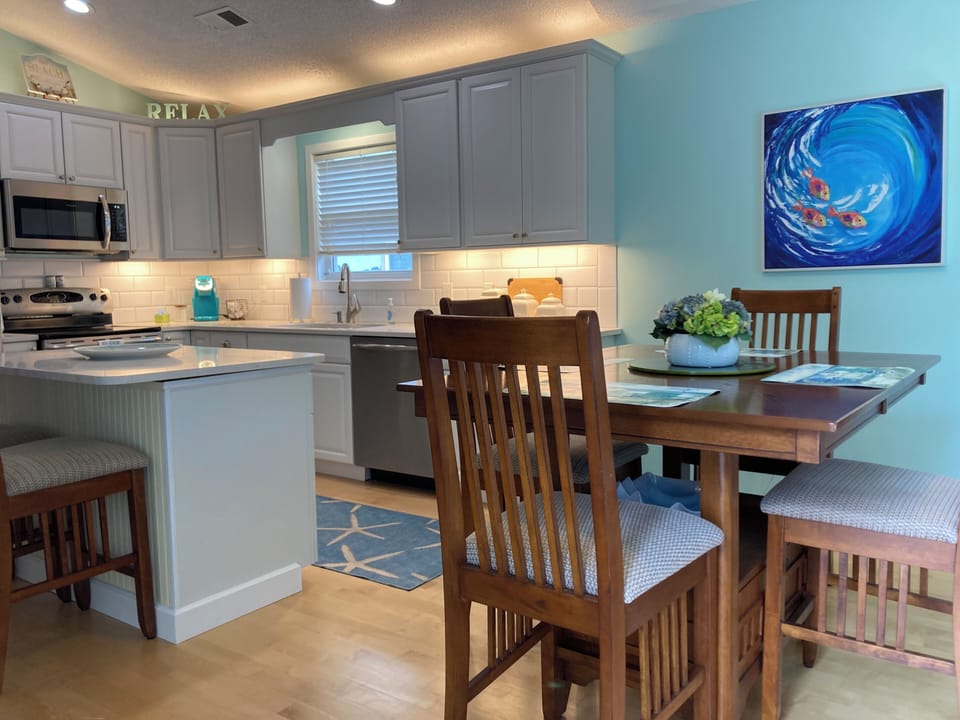Open kitchen and dining area with additional seating at the center island
