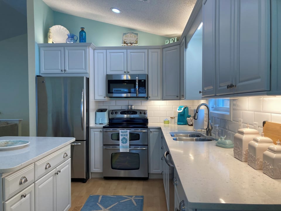 Stainless steel appliances with a double oven range.