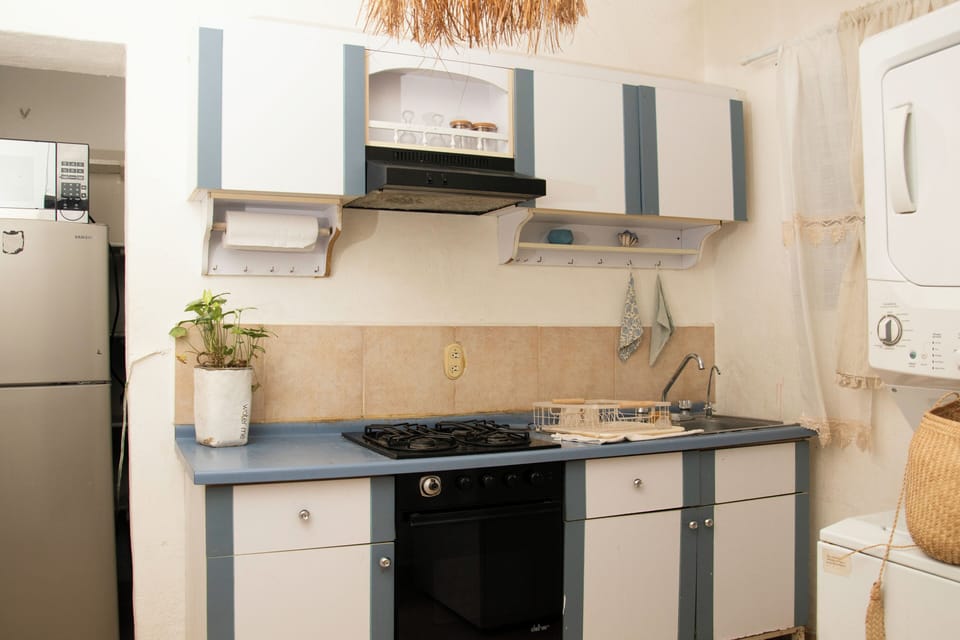 Fridge, microwave, coffee/tea maker, cookware/dishes/utensils