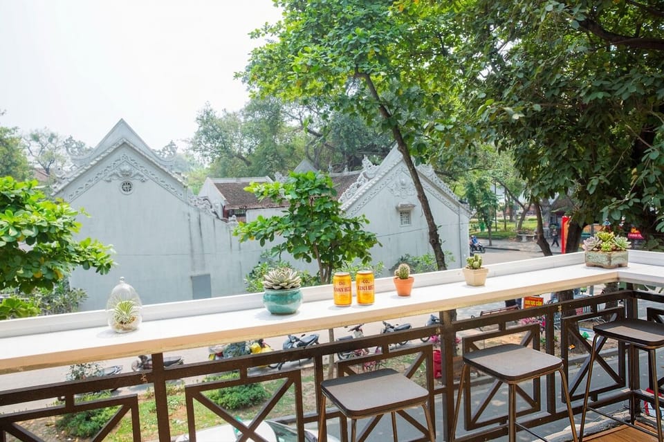 Enjoy coffee or drinks on the balcony overlooking Old Quarter street life