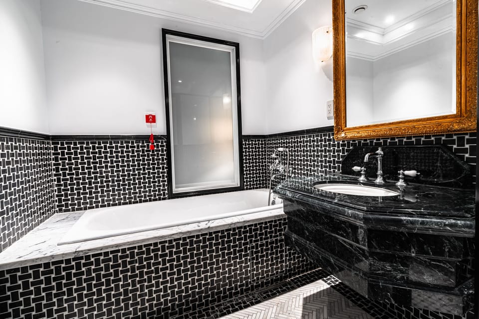 Separate tub and shower, hair dryer, slippers, towels