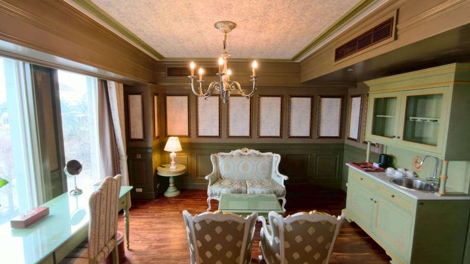 Exclusive Quadruple Room | Living area | 36-inch flat-screen TV with cable channels