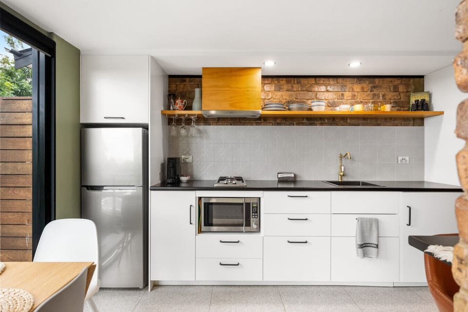Whip up hearty meals in the well-equipped kitchen with modern appliances including a two-burner stove, microwave, and an Aldi Expressi for an easy stay.
