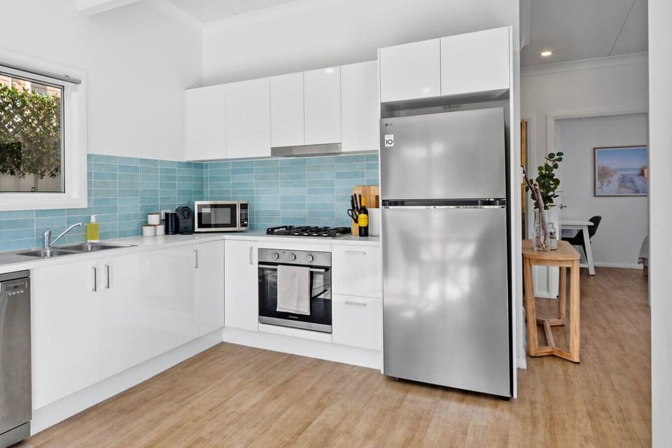 Full kitchen — gas cooktop, oven, coffee