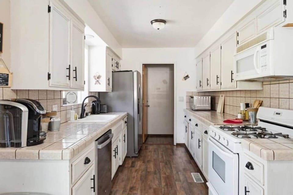 Spacious kitchen with white cabinetry and ample storage