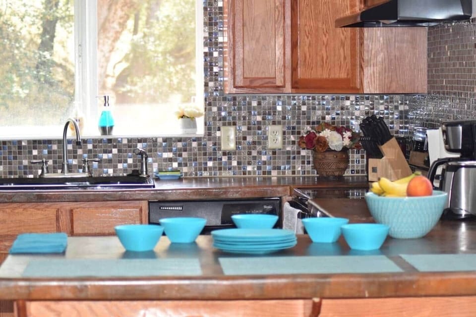 Stocked kitchen with colorful dishware — make a charcuterie board and pair it with wine down by the water