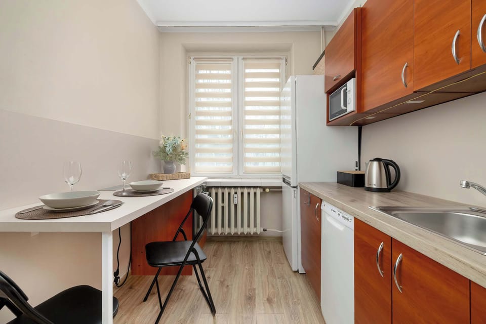Fully equipped modern kitchen with sleek cabinetry, ample counter space, and all essential appliances.