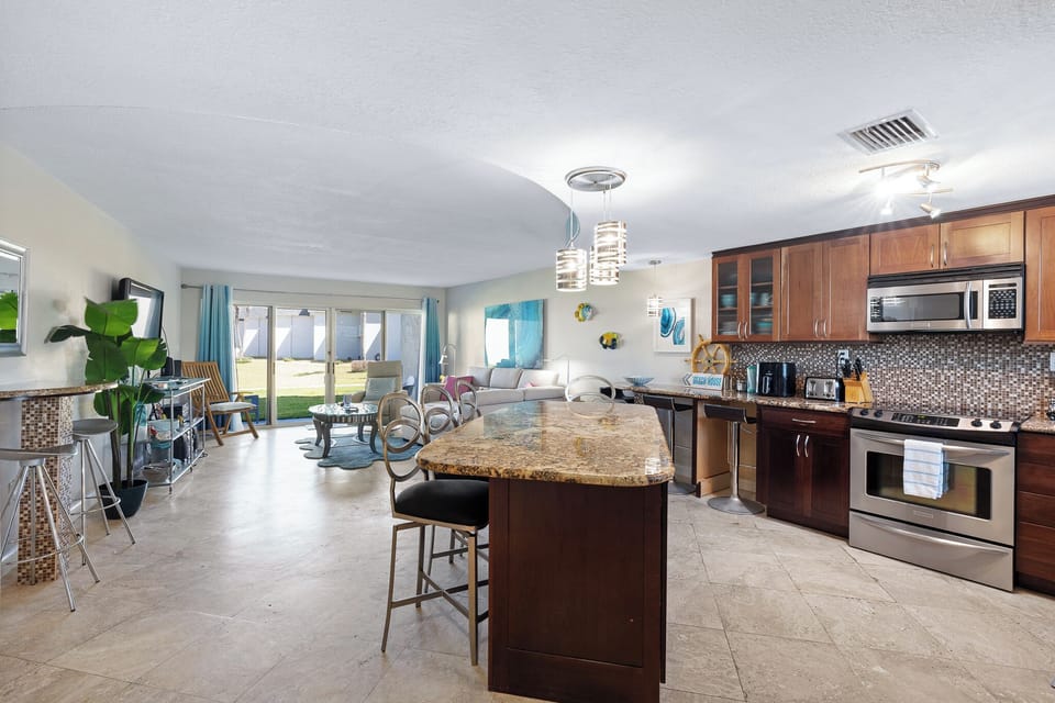 Open platform layout with kitchen island and bar chairs