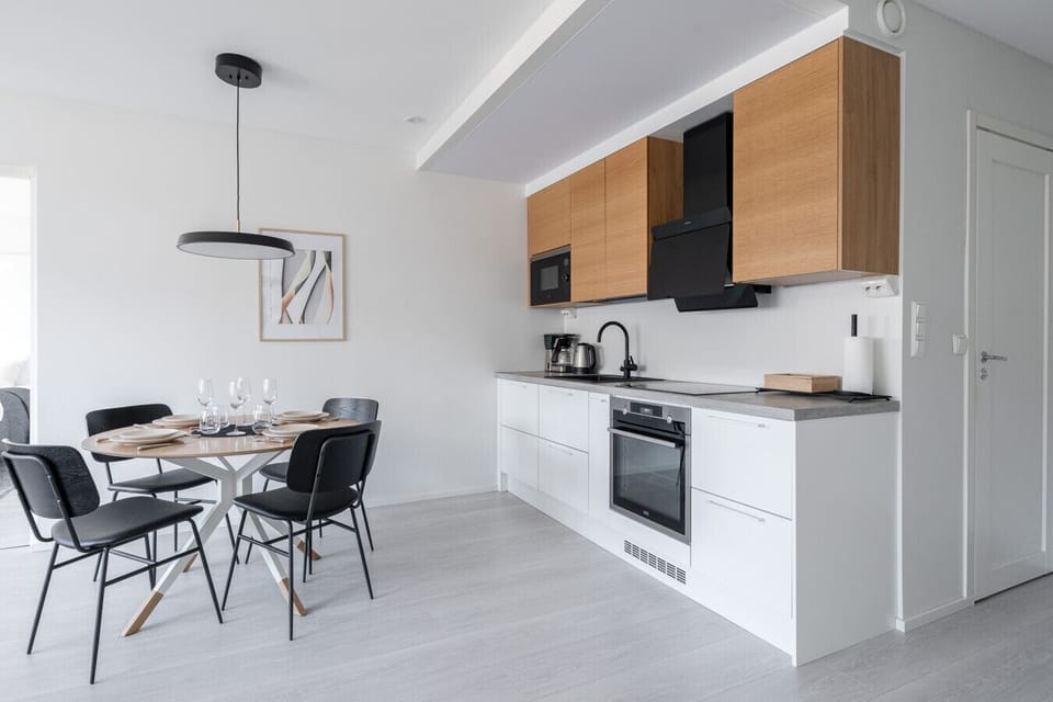 Cook like a pro. This sleek, modern kitchen features a premium AEG induction cooktop and integrated oven, providing everything you need for a gourmet meal at home