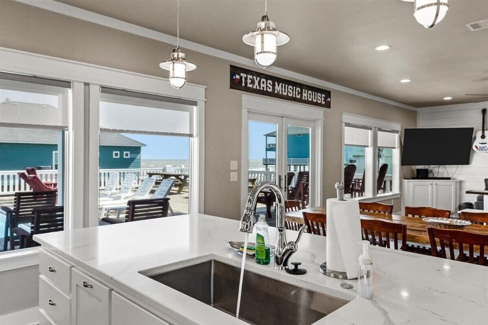 Open kitchen and dining area with bright windows and coastal décor in Crystal Beach