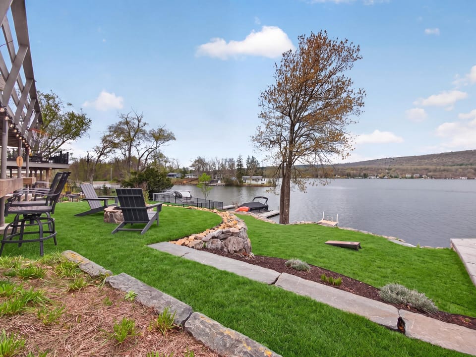 Expansive waterfront lawn with direct lake access
