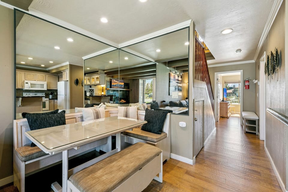 Gather around this inviting dining booth with ample seating for meals and laughter. The open layout flows seamlessly into the full kitchen and living area, creating your perfect home base.