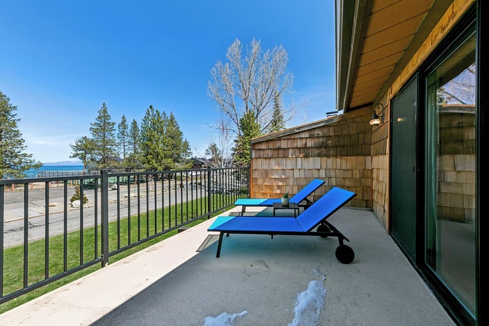 Step outside to your private balcony with two lounge chairs perfectly positioned to catch fresh air and glimpses of natural surroundings through the trees.