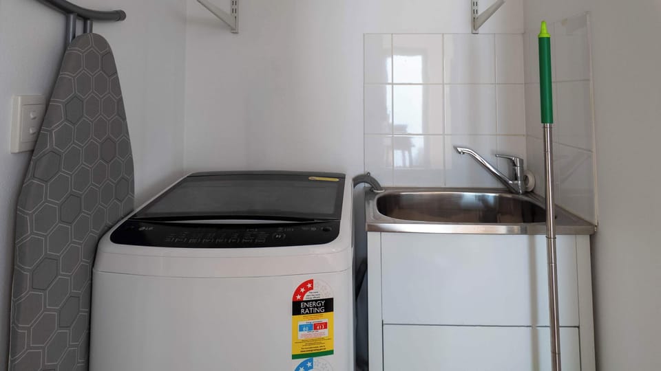 Built in Laundry with washing machine and laundry sink, hanging rack for drying in either patio with lovely ocean breeze. 