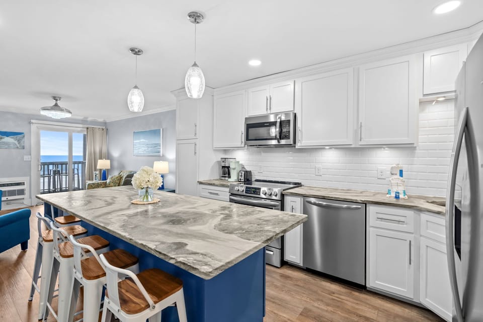 Fully stocked kitchen with updated appliances + island seating for 6