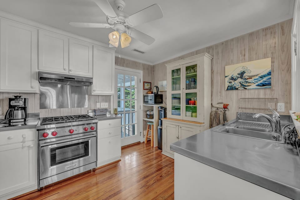 You'll love preparing meals in this beautifully appointed kitchen with stainless steel appliances, abundant counter space, and charming coastal-inspired details.