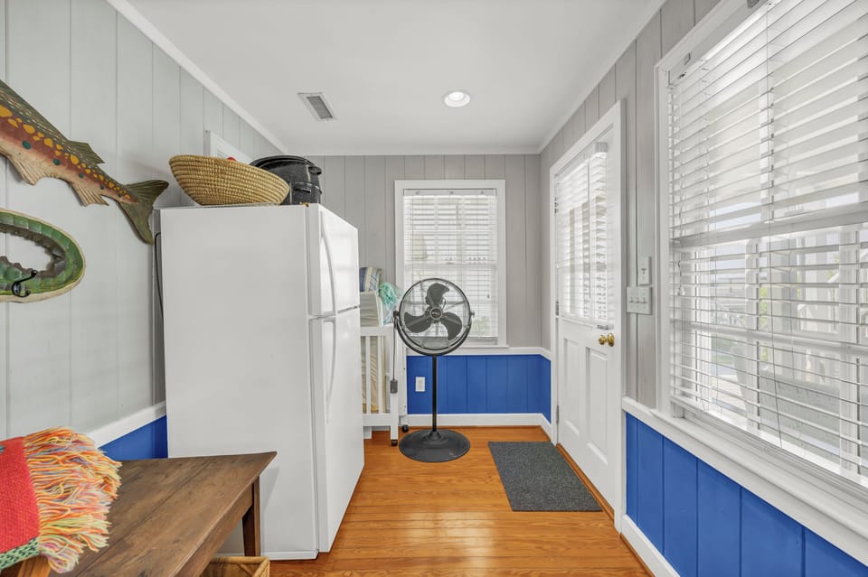 Your bright kitchen welcomes you with cheerful blue accents, gleaming hardwood floors, and everything you need to create memorable meals during your stay.