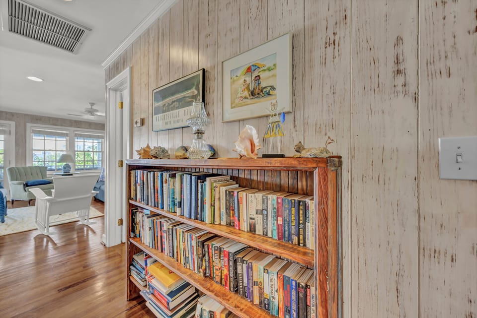 Curl up with a good book from your personal library, surrounded by coastal charm and weathered wood walls.