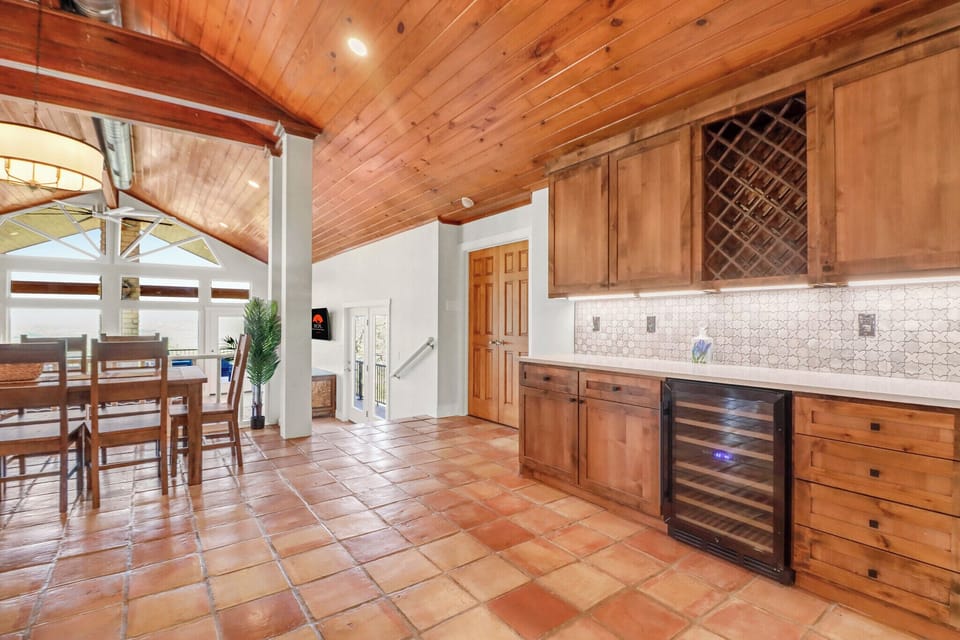 Step into your gourmet kitchen with rich wood cabinetry, where rustic charm meets modern convenience for memorable meal preparation.