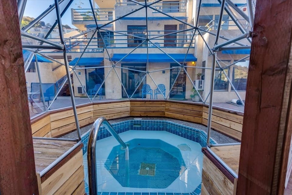 Unwind in the cozy hot tub beneath a breezy canopy.