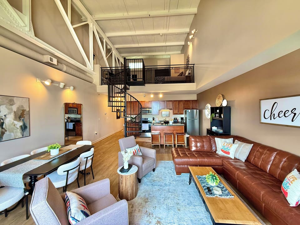 From cozy seating to the spiral staircase, this space brings it all together—open, airy, and designed for groups to relax, recharge, and feel right at home.