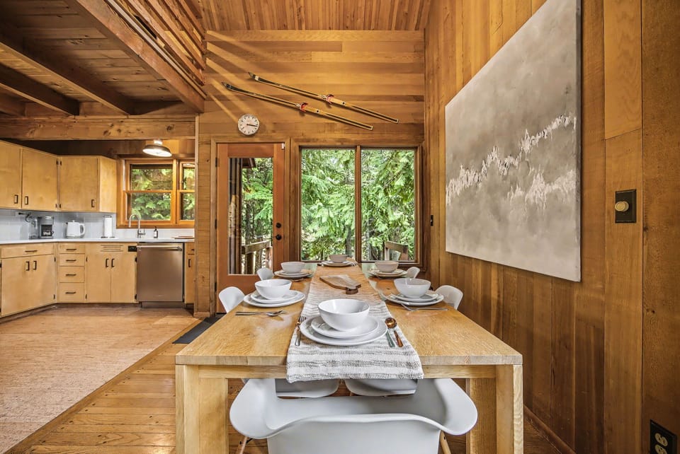 Spacious dining room with scenic forest backdrop & rustic elegance.