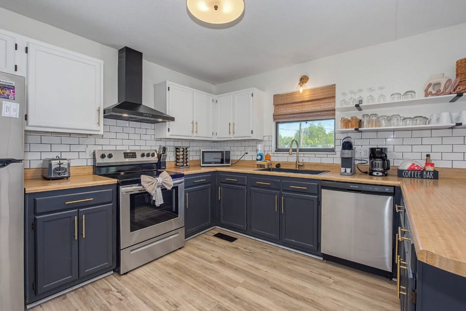 Your fully equipped kitchen features warm wood countertops and modern appliances, perfect for preparing memorable meals during your stay.