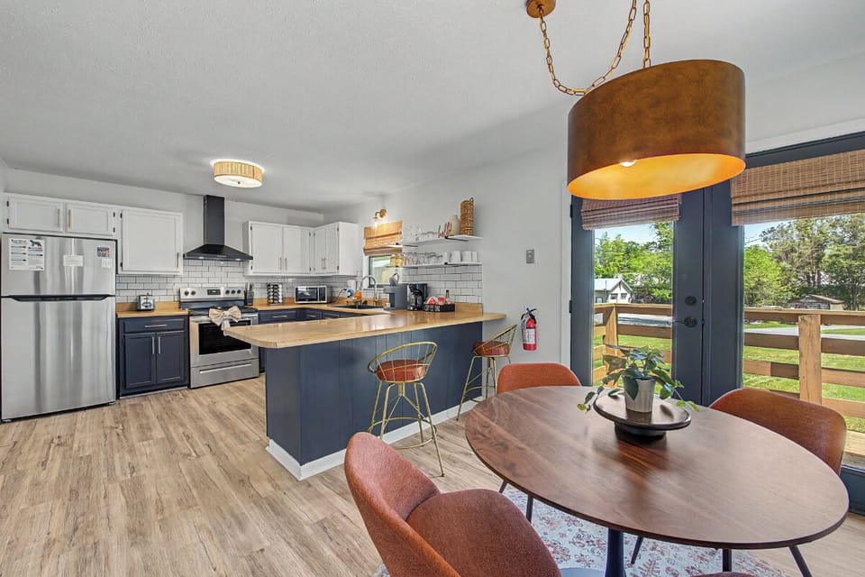 Your stylish kitchen flows seamlessly into the dining area, featuring modern appliances and warm lighting where memorable meals await.