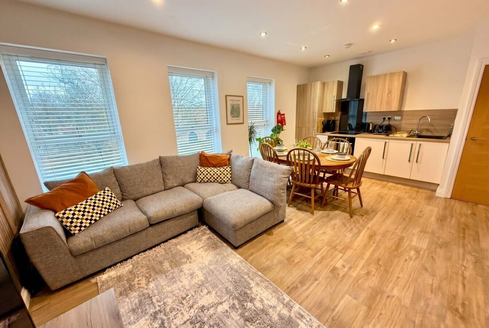 Sunlit lounge flows seamlessly into the dining area and fully equipped kitchen beyond.