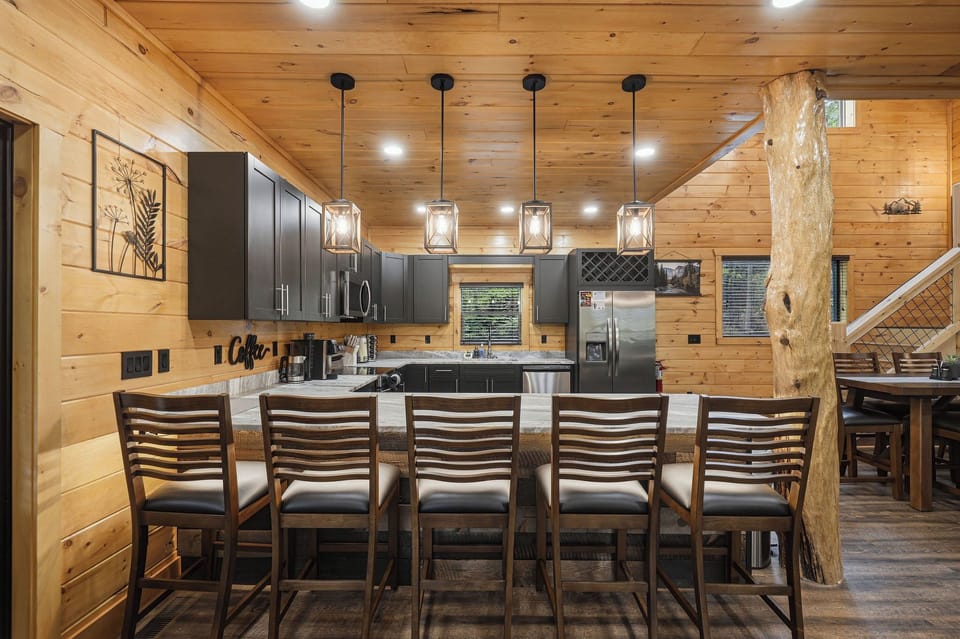 Gather around your rustic kitchen island where warm wood meets modern style—perfect for morning coffee or evening meals together.
