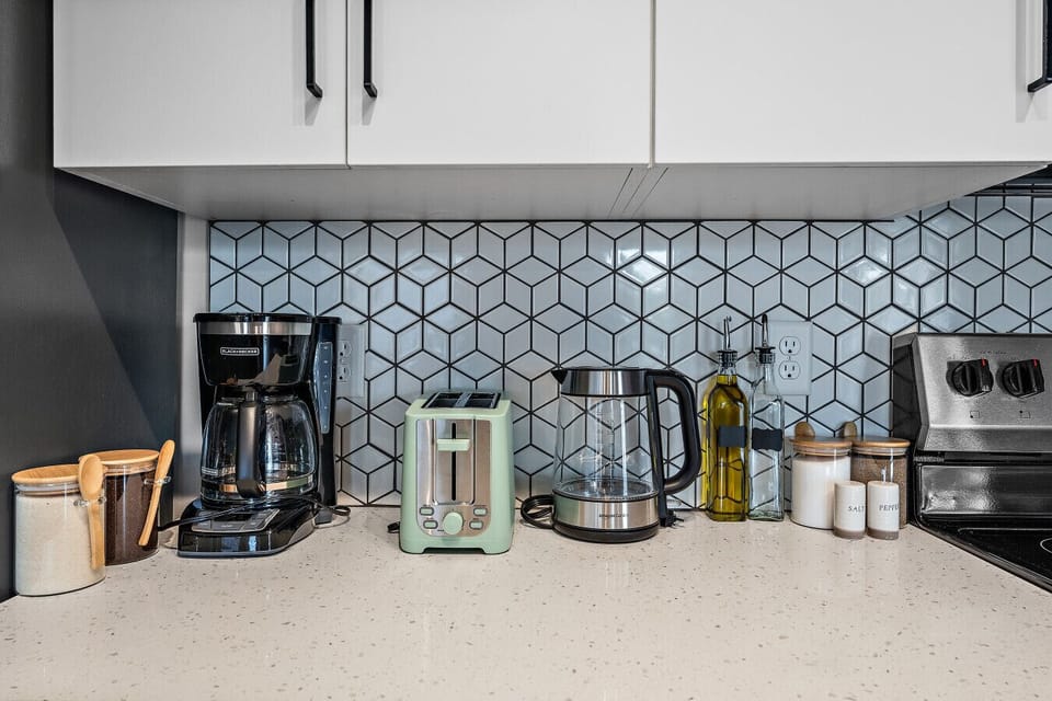 Whip up culinary delights in our stylish, fully equipped kitchen featuring modern amenities!