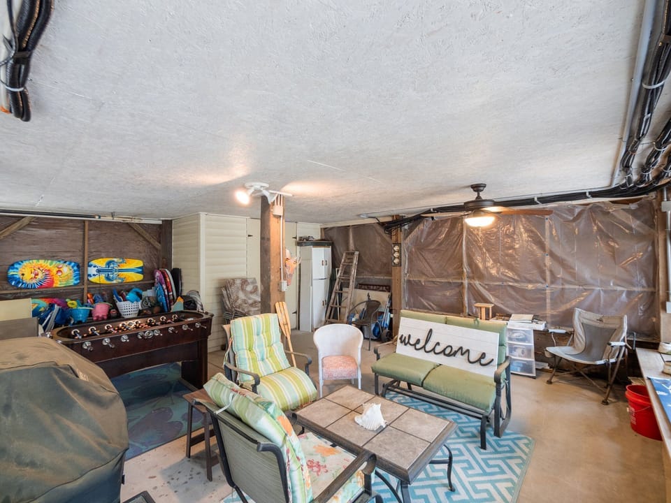 Your garage entertainment space offers game tables, seating, and beach gear storage for relaxing between adventures.