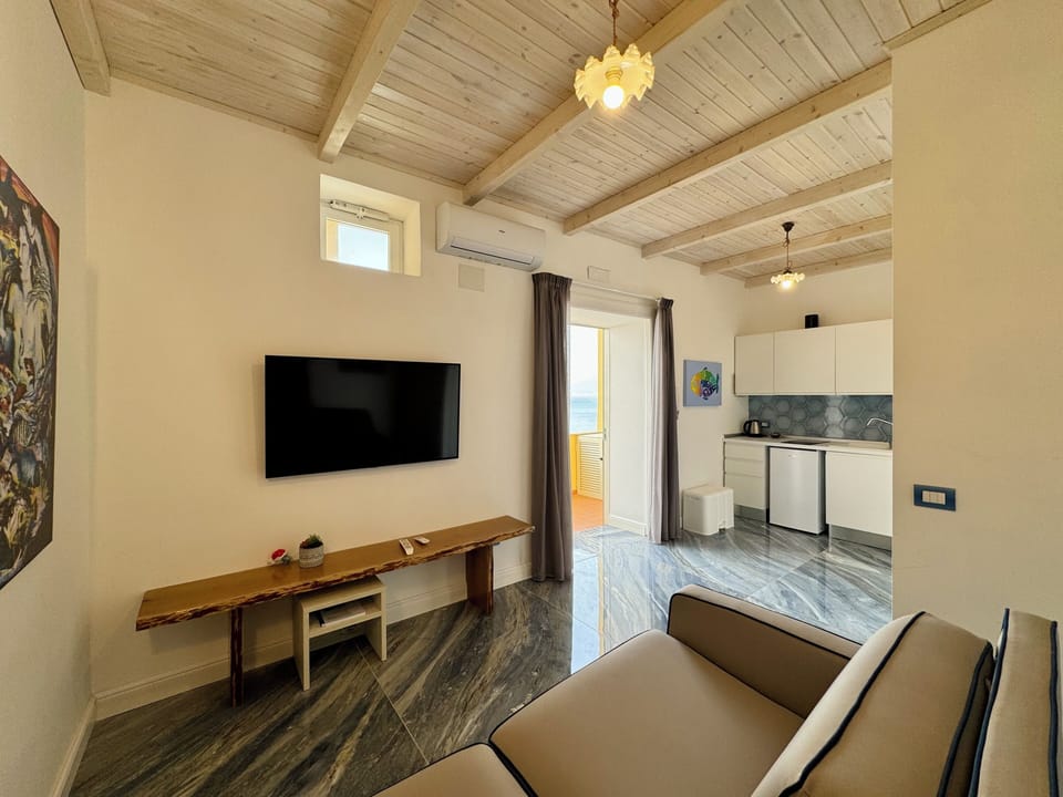 Apartment, Balcony, Sea View | Living area | 32-inch flat-screen TV with digital channels