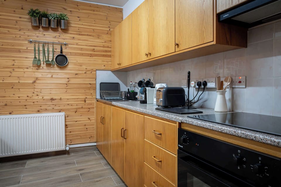 A bright, open-plan kitchen and living area with all the amenities you need to cook, dine, and unwind with ease after a day out.