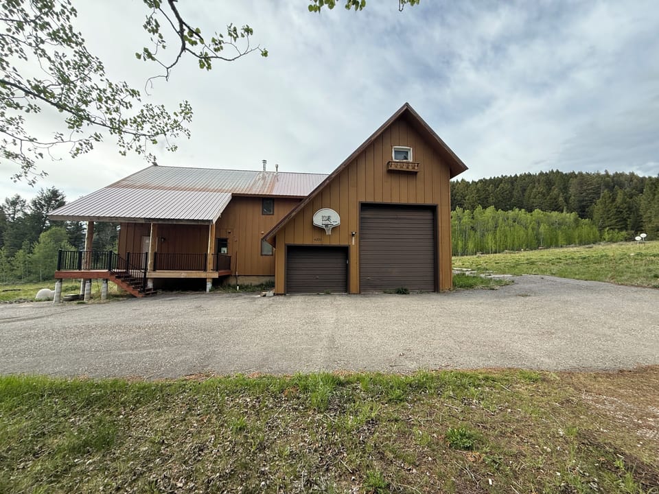 Front view of home and paved driveway with Mountain in the background