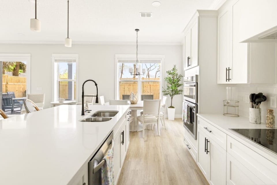 Spacious kitchen with modern finishes, ample counter space, and a bar top perfect for casual dining 🥂