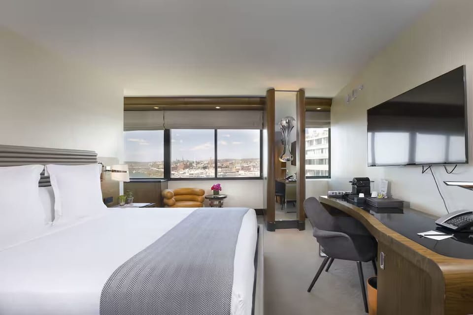 Settle into a serene king bed with skyline views.