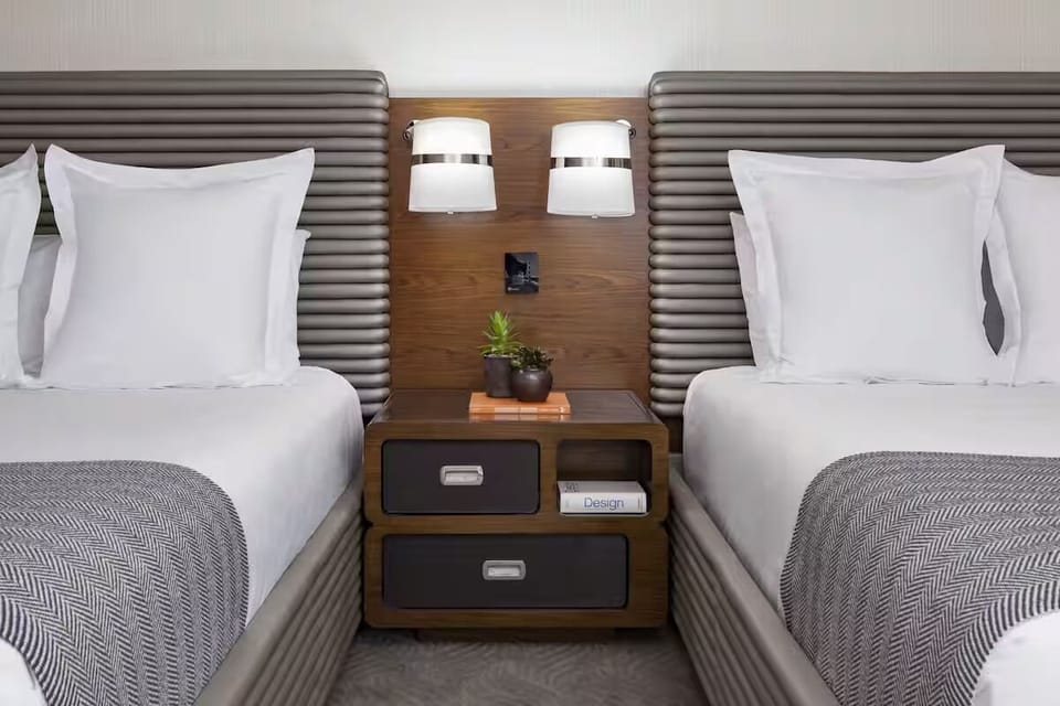 Settle in between twin beds with soft, hotel linens.