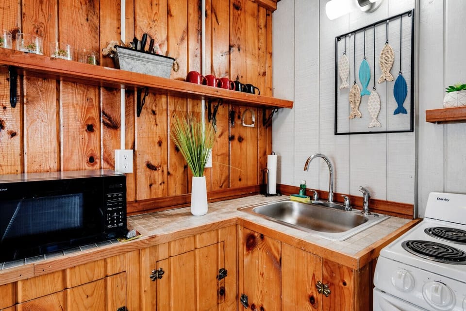 Cabin 1 Kitchen | Stainless Sink | Microwave & Wood Cabinetry