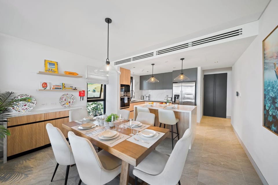 Fully equipped kitchen features high-end appliances and a sleek breakfast bar