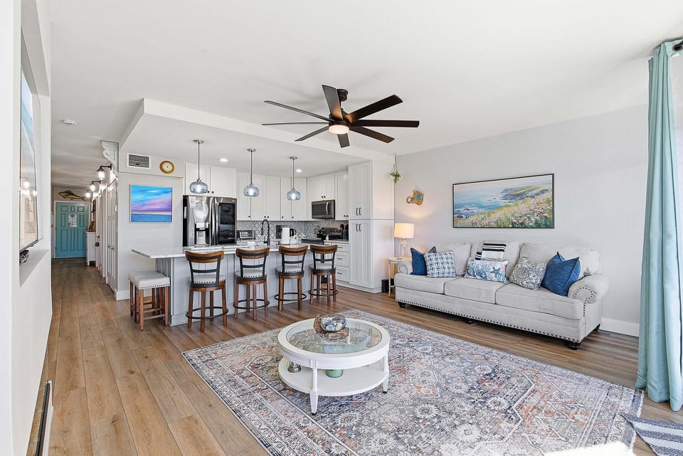 Enjoy a relaxing beach stay in this spacious open-concept condo featuring a modern kitchen, bar seating, and cozy coastal living area. Perfect for gathering, unwinding, and making the most of your time near the beach.
