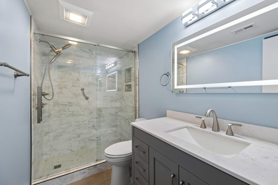 Bedroom 2: 1 Queen bed, closet space, Smart TV, access to hallway bathroom with walk-in shower