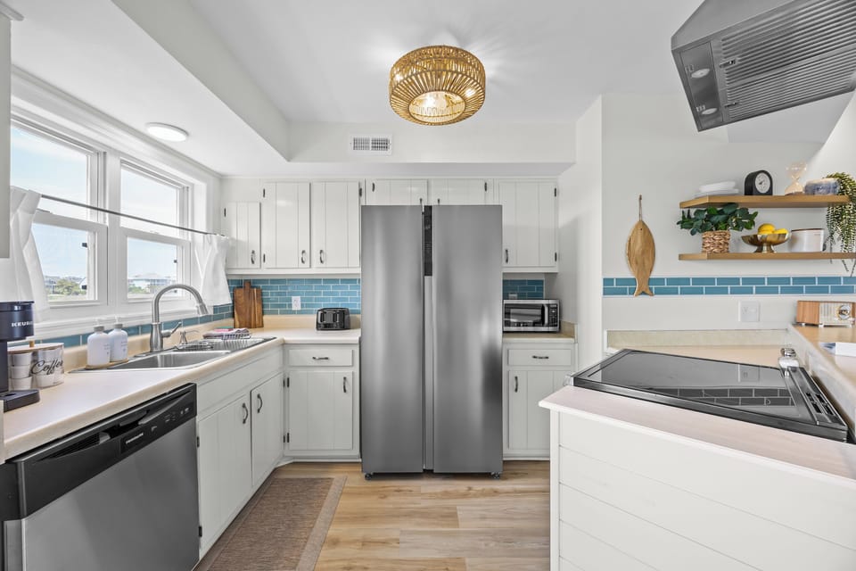 Cook with ease in a well‑stocked kitchen featuring a Keurig, drip coffee maker, and all essentials for meals at home. Ideal for extended stays or families who love convenience.