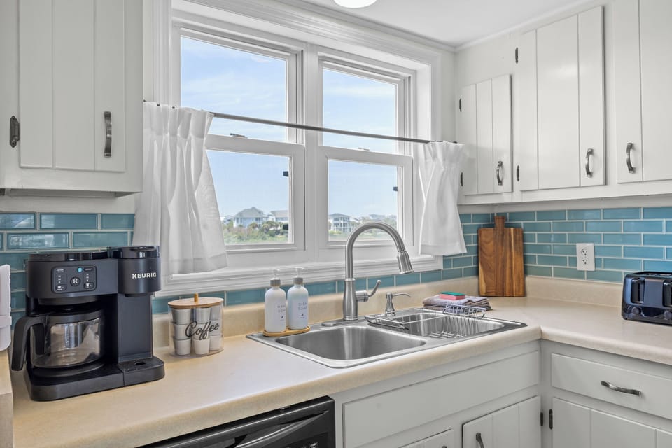 Cook with ease in a well‑stocked kitchen featuring a Keurig, drip coffee maker, and all essentials for meals at home.