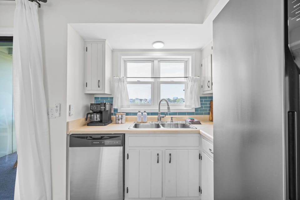 Cook with ease in a well‑stocked kitchen featuring a Keurig, drip coffee maker, and all essentials for meals at home.