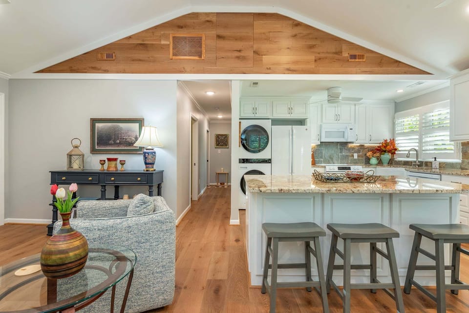 Open living, dining, and kitchen areas.