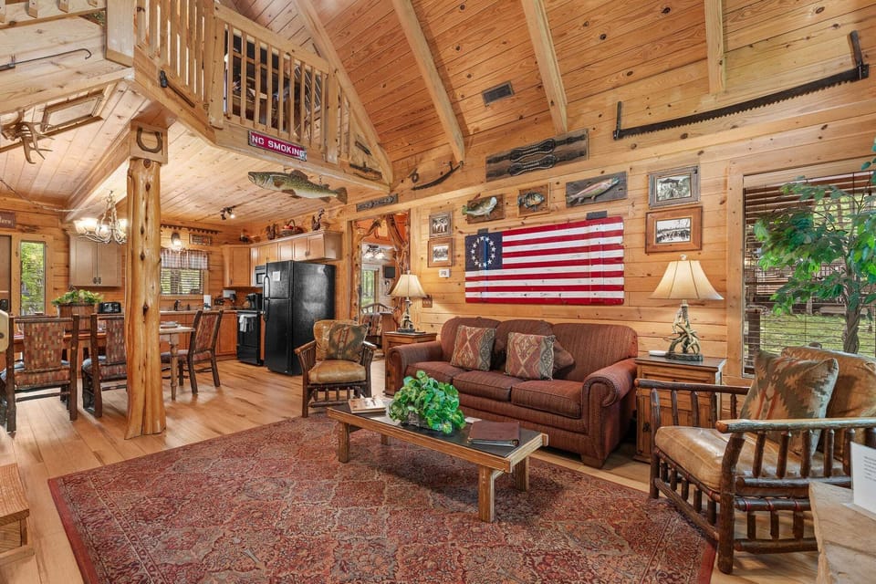 The living room features a sleeper sofa, a seasonal fireplace, cable TV, and access to the patio.