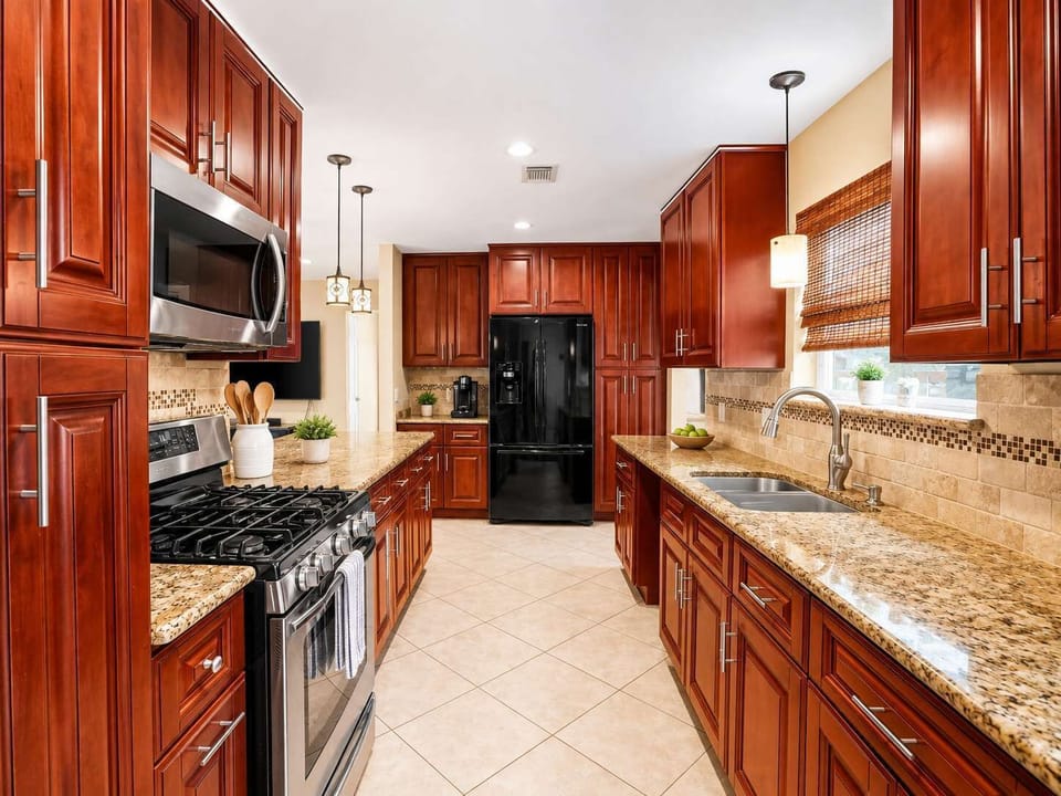 Gourmet Kitchen: Cook up a feast in stylish red cabinets with modern appliances and ample space!