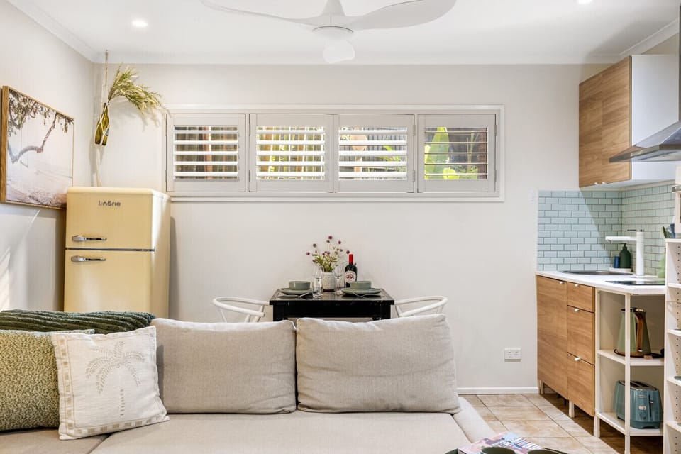 Open plan living, dining and kitchenette with balcony access